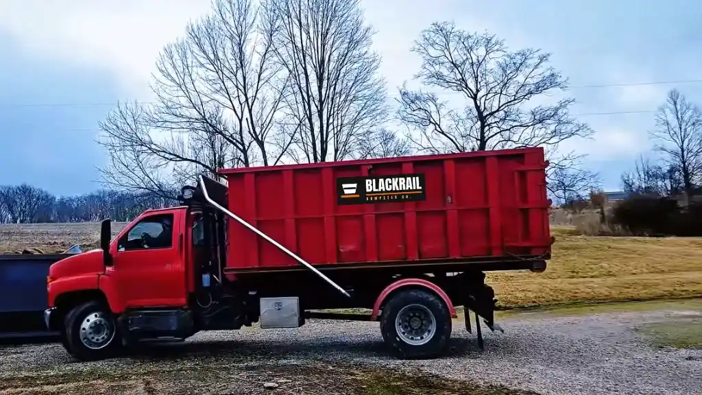 Red Blackrail Dumpster Co. dumpster truck providing junk removal and debris hauling in Lubbock, Texas.
