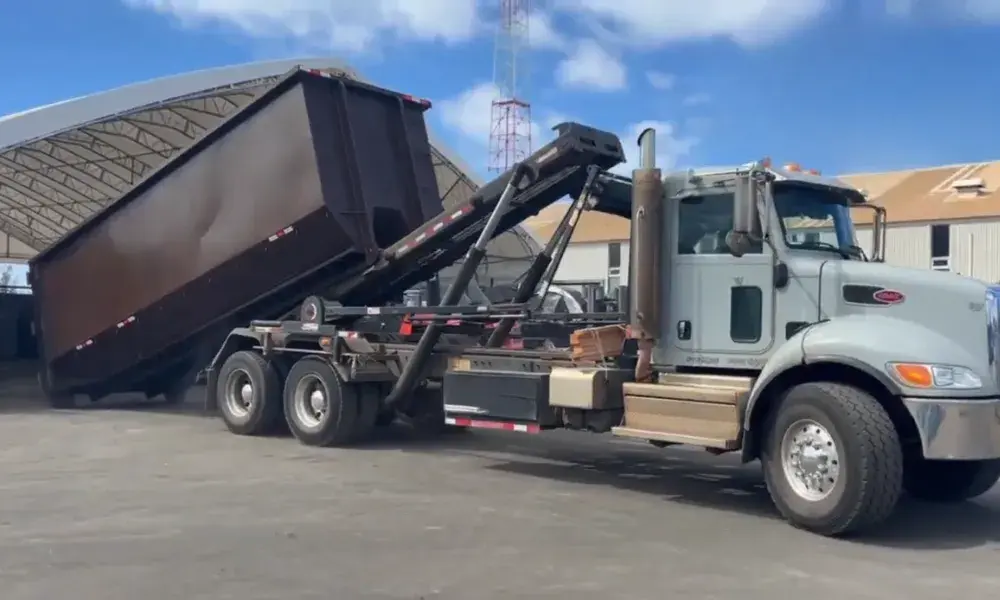 Commercial dumpster rental Lubbock roll-off truck delivering a dumpster